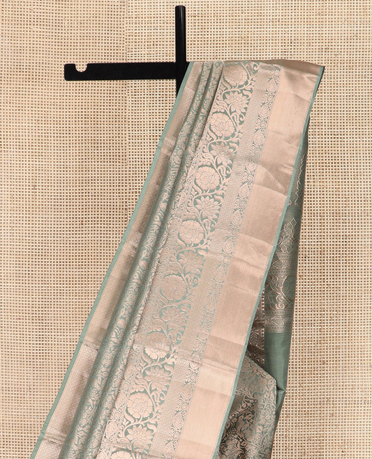 Green Kanchipuram Silk Saree Highlighted by Jacquard Design, Complemented by Zari Border of Thilakam Mokku, Manga, Jaal, and Kodi Visiry Designs, Pallu Elevated with Intricate Zari Designs, and Paired with a Matching Blouse