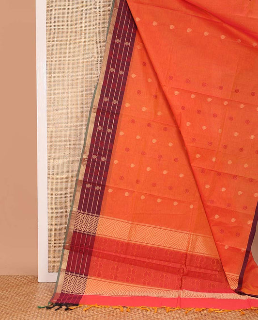 Orange chakra, and paisley buttas Coimbatore cotton saree, contrast butta enclosed checked border, and pallu of paisleys and chevron design