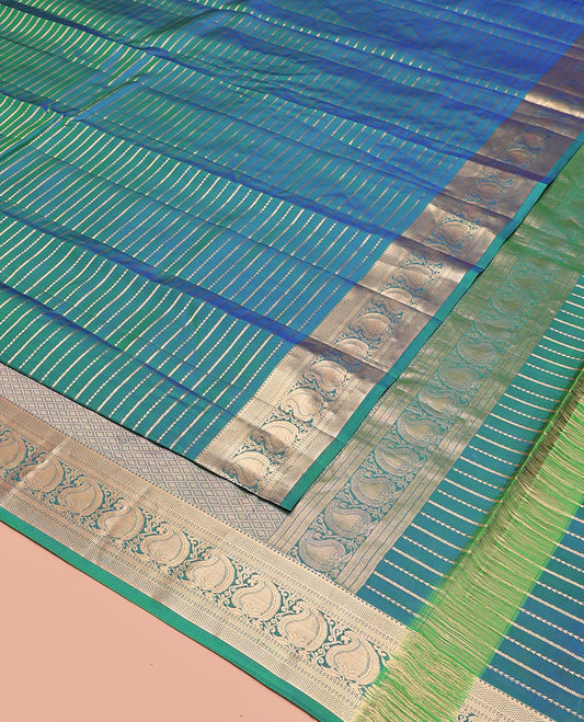 Blue Vasundhara Silk Saree Richly Detailed with Zari Buttas, Highlighted by a Zari Border of Rekku, Kuyil Kann, Neli, and Manga Designs, Delicately Woven Pallu of Jaal Designs, and Paired with a Matching Blouse