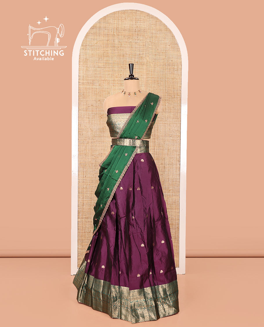 Purple and Green Semi-Banarasi Half-Saree, Beautified with Zari Buttas on Its Skirt, Complemented by a Contrast Traditional Zari Design Woven Border, Paired with a Matching Blouse, and a Contrast Satin Georgette Embroidered Scallop Dhavani