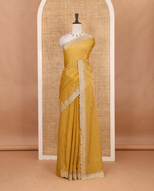 Mustard Swarovski crystal stone embedded fendy chiffon saree, scallop Swarovski stone embroidered border, and contrast plain blouse