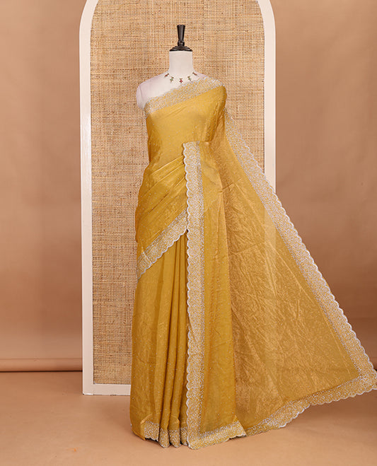 Mustard Swarovski crystal stone embedded fendy chiffon saree, scallop Swarovski stone embroidered border, and contrast plain blouse