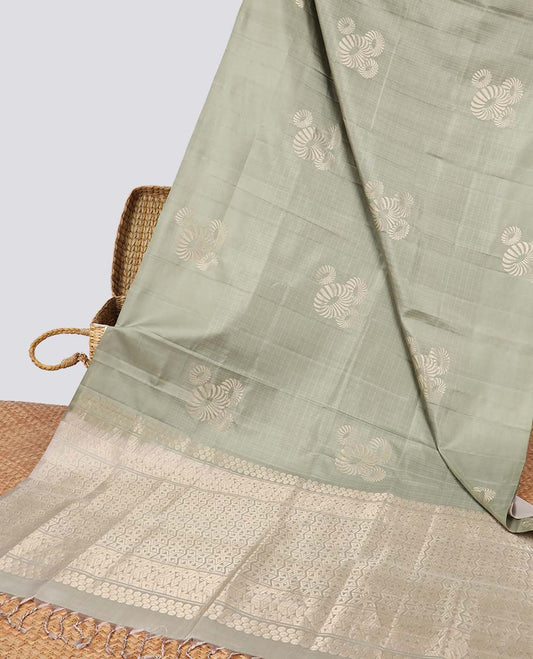 Borderless green buttas soft silk saree with intricate zari design pallu