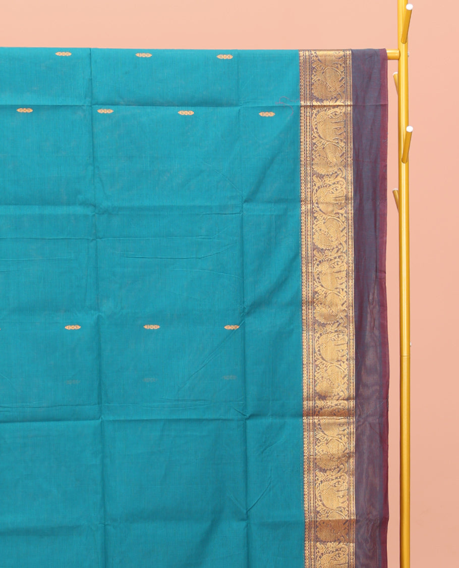Blue Chettinad Cotton Saree, Adorned with Buttas All Over Its Body, Complemented by a Contrast Ganga-Jamuna Kal Eragina Border of Kodi Peacock and Elephant Designs, Pallu of Buttas and Stripes, and Paired with a Matching Blouse