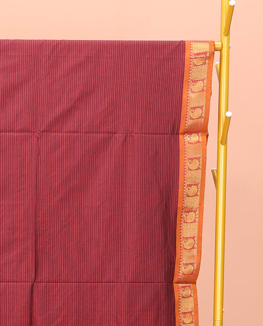 Maroon Poly Cotton Saree, Subtly Sparkled with Stripes on Its Body, Complemented by Contrast Traditional Zari Border of Paisleys, Striped Pallu, and Paired with a Contrast Blouse