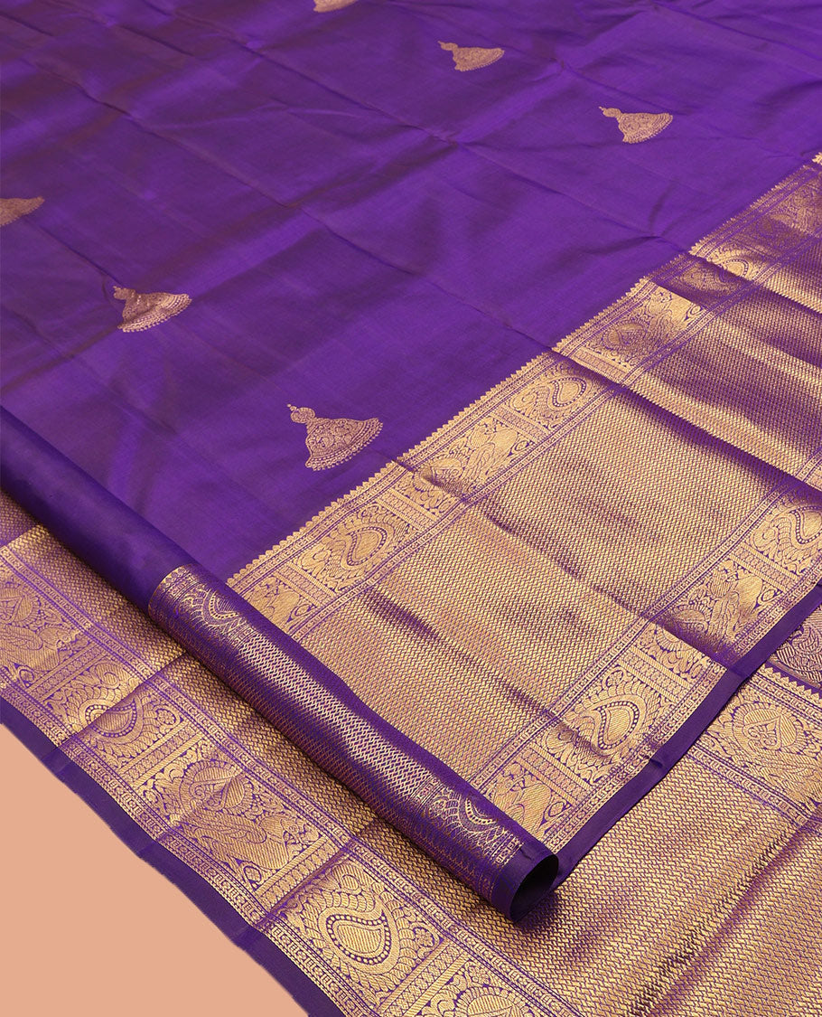 Violet Kanchipuram Silk Saree, Opulently Embellished with Jhumka Zari Buttas, Highlighted by a Zari Border of Arumbu Manga, Mayil, and Paiyadi Kann, Grand Pallu, and Matching Blouse