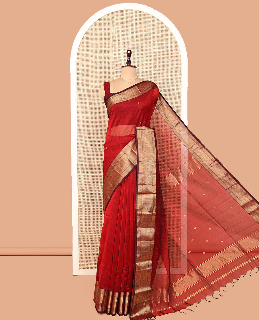 Red Maheshwari Cotton Saree, Accentuated with Buttas All Over Its Body, Complemented by a Contrast Traditional Zari Woven Border of Chevron Designs, Pallu Mirrors the Same Design, and Paired with a Matching Blouse