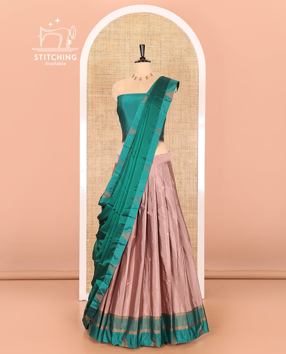 Fawn and green half-saree with buttas with contrast traditional bordered taffeta silk skirt, a matching blouse, and a contrast bordered syska georgette dhavani
