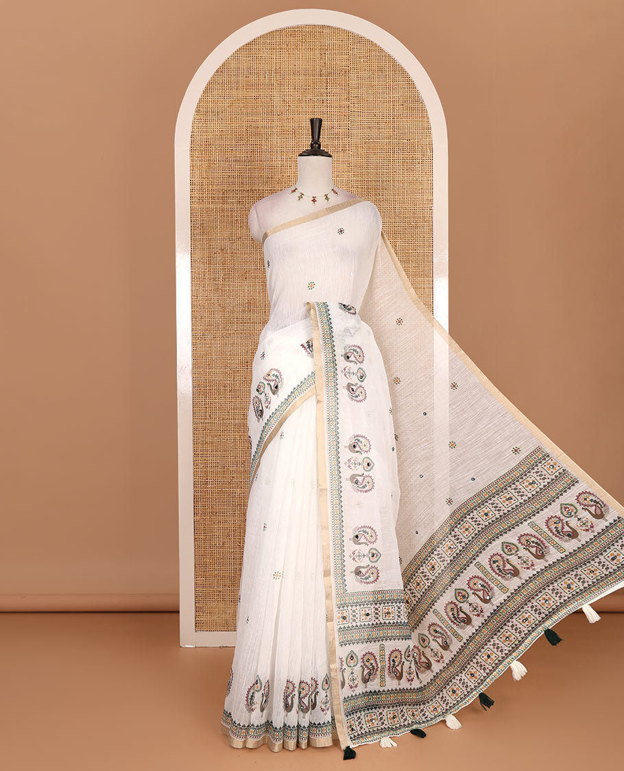 Half-white buttas with mirror work linen saree,  zari border with peacock motifs print, printed mirror work pallu, and matching blouse