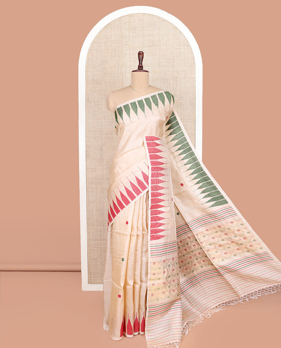 Cream Tussar Silk Saree, Finely Woven with Multi-Color Thread Buttas All Over Its Body, Subtly Sparkled with Temple Border, Pallu Depicts Flower Butta Enclosed Jaal Designs, and Paired with a Matching Blouse