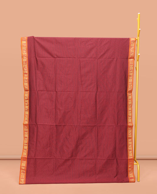 Maroon Poly Cotton Saree, Subtly Sparkled with Stripes on Its Body, Complemented by Contrast Traditional Zari Border of Paisleys, Striped Pallu, and Paired with a Contrast Blouse