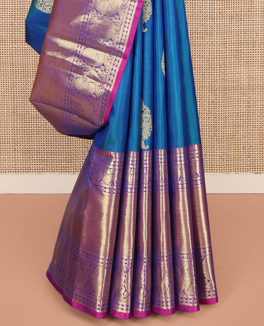 Blue Kanchipuram Silk Saree, Embellished with Zari Buttas All Over Its Body, Complemented by a Contrast Border of Manga Mokku, Poun, Yaali, and Mayil Designs, Pallu of Kodi Visiry Designs, and Paired with a Contrast Blouse