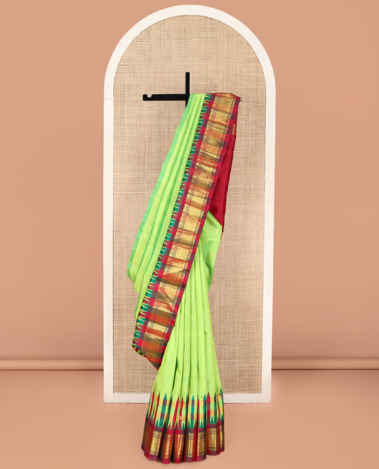 Green Kanchipuram Silk Saree, Delicately Woven with Zari Buttas on Its Body, Complemented by a Contrast One-Sided Thazampoo Rekku Border of Mayil and Jaal Designs, Pallu Depicts Zari Designs, and Comes Without a Blouse