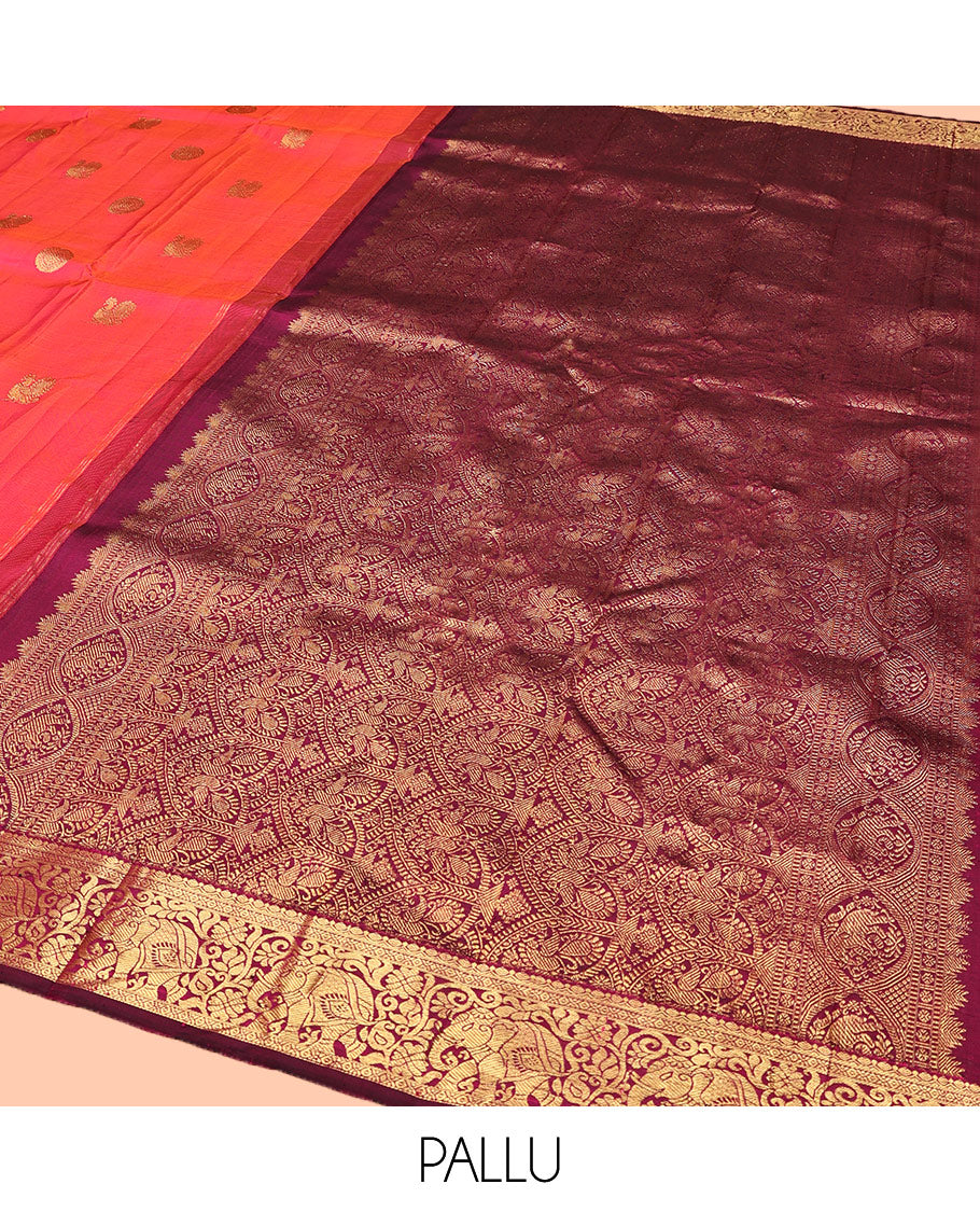 Orange Kanchipuram Silk Saree, Mesmerized with Mayil and Chakram Buttas All Over Its Body, Complemented by Contrast Border of Thilakam, Cross Kamalam, and Yaanai Designs, Pallu Steeped with Rettai Mayil Designs, and Paired with a Contrast Blouse