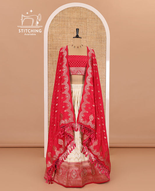 Cream-pink chiniya crepe half-saree, chevron zari jacquard with contrast intricate patterned stone work bordered skirt, contrast blouse, and a scallop bordered intricate dhavani