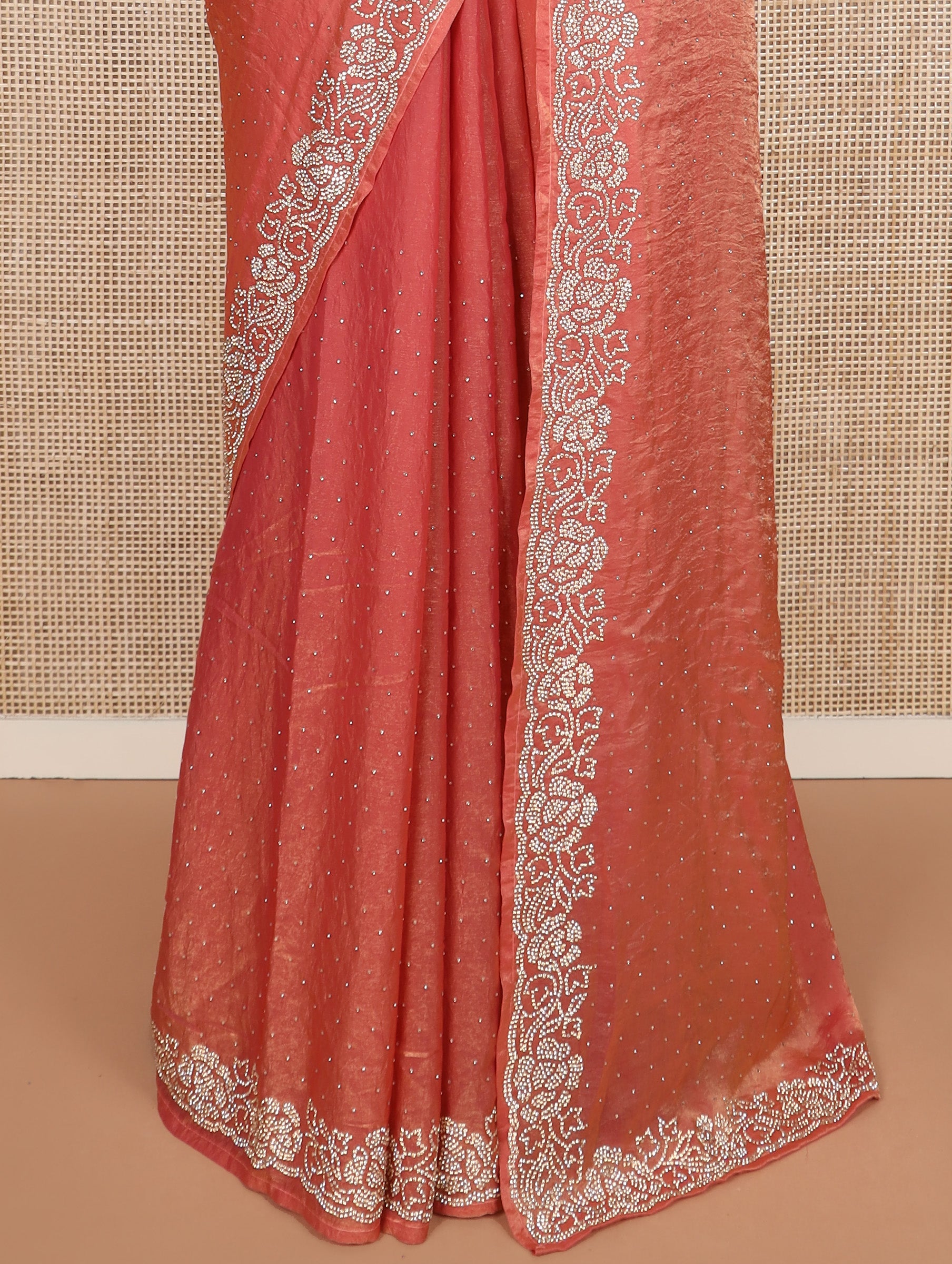 Peach stone work designer saree, micro-stone work border, and a contrast half-sleeve blouse of floral vine design in micro stones