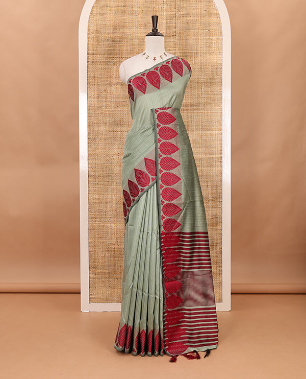 Pista green plain jute cotton saree , contrast leaf thread butta border & lining seer pallu with tussels