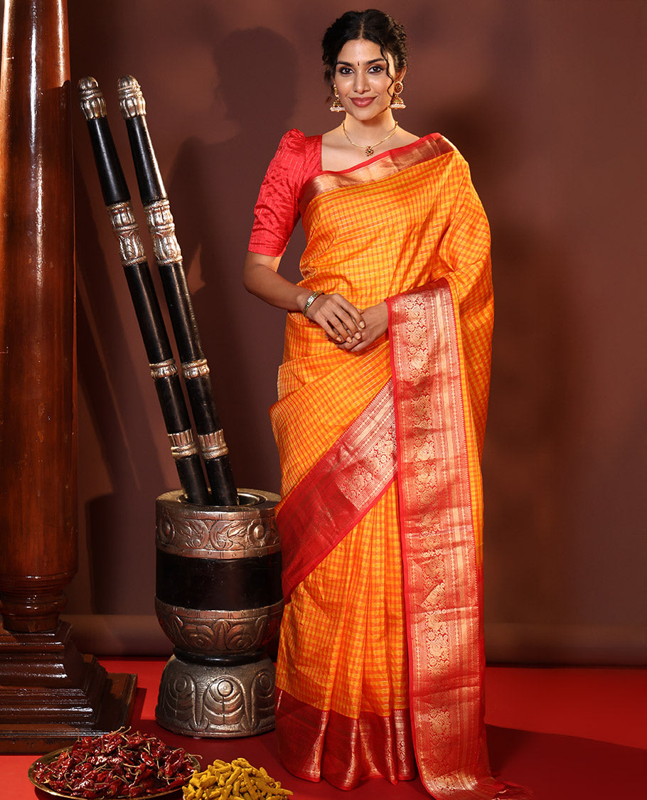 Orange Vasundhara Silk Saree Decked Up with Checks All Over Its Body, Complemented by Contrast Border of Rekku, Neli, Rudraksham, Kathir, and Mayil Designs, a Grand Pallu of Intricate Designs, and Paired with a Contrast Blouse
