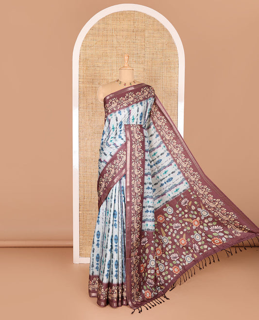 Blue shibori printed katan silk saree, contrast border, and pallu of kalamkari floral vine and peacock print, and a contrast leaf printed blouse