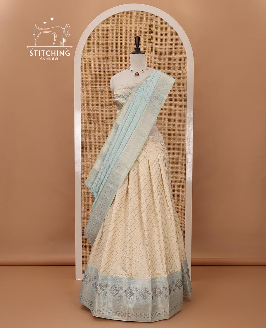 Cream semi-banaras material chudidar,leheriya zari skirt,contrast sea blue zari & swarovski stonework border,jacquard blouse & zari weave dhavani