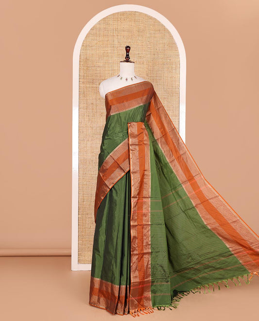 Green plain semi-soft silk saree, contrast zari striped border, striped pallu, and matching blouse