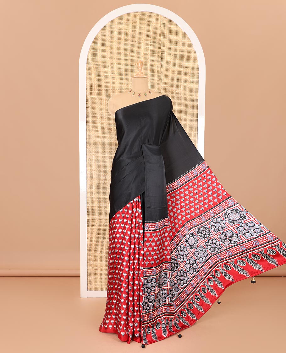 Borderless black-red half-and-half style, intricately Ajrakh printed satin crepe saree with a contrast lotus floral printed blouse