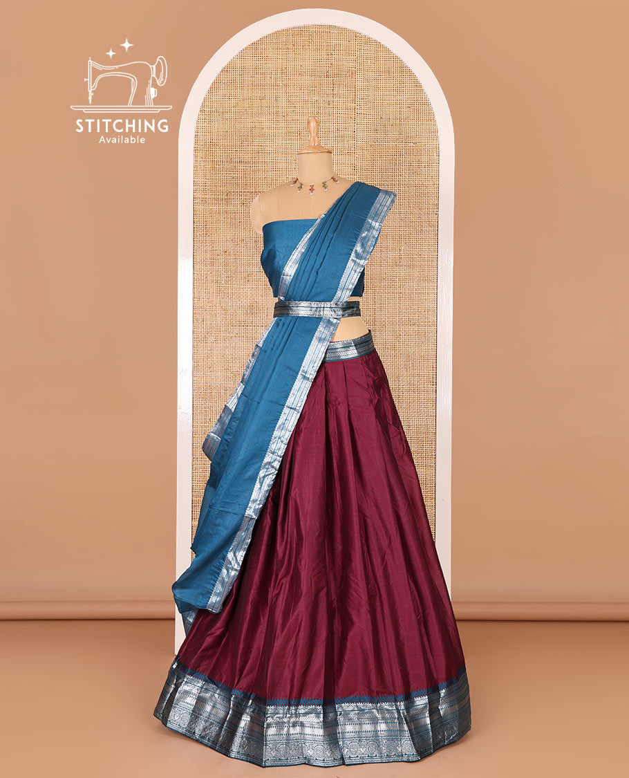 Magenta taffeta silk half-saree, plain with a contrast traditional design bordered skirt, contrast blouse, and traditional zari bordered blouse