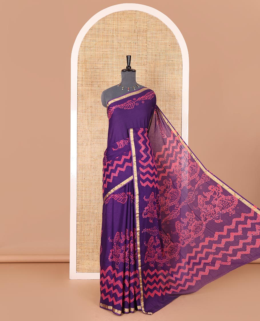 Violet wax batik-style zig-zag printed pure cotton saree, gold zari piping border, human figurines batik printed pallu, and a matching blouse