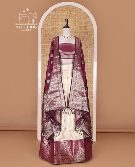 Cream with purple semi-banarasi half-saree, zari buttas with contrast traditional zari border skirt, zari jacquard blouse, and zari design dhavani