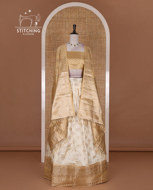 Cream and gold  semi-banarasi half-saree, zari buttas with contrast swarovski stone work border skirt, contrast zari buttas blouse, and intricate zari dhavani