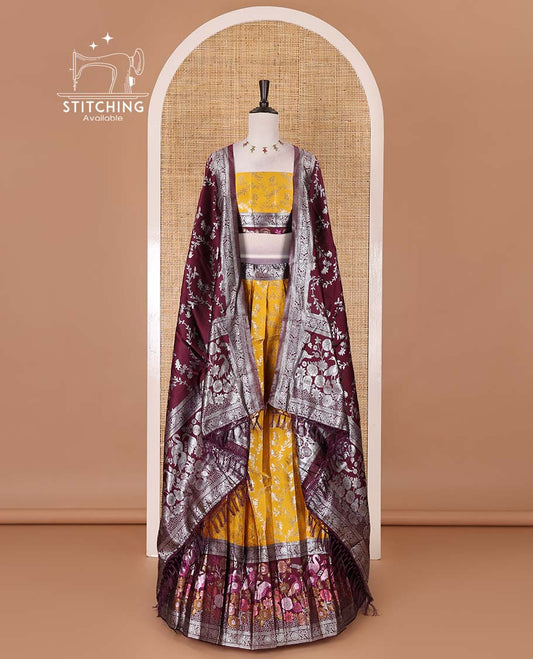Haldi yellow taffeta silk half saree, floral jaal jacquard skirt, contrast wine zari meenakari style bird border, matching blouse, and floral jaal dhavani