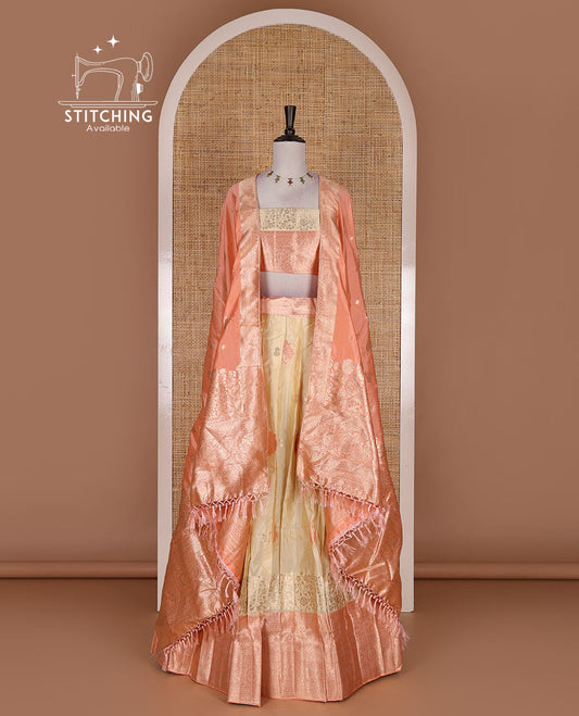 Cream taffeta silk half saree, meena buttas skirt, contrast peach traditional zari border, matching blouse, and zari woven dhavani