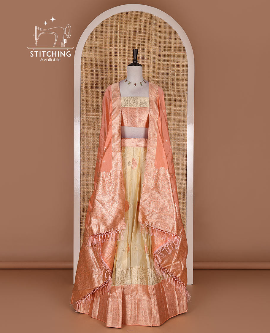 Cream taffeta silk half saree, meena buttas skirt, contrast peach traditional zari border, matching blouse, and zari woven dhavani