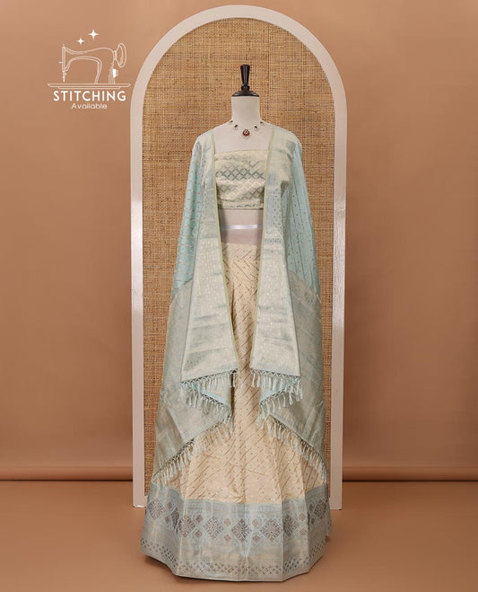 Cream semi-banaras material chudidar,leheriya zari skirt,contrast sea blue zari & swarovski stonework border,jacquard blouse & zari weave dhavani
