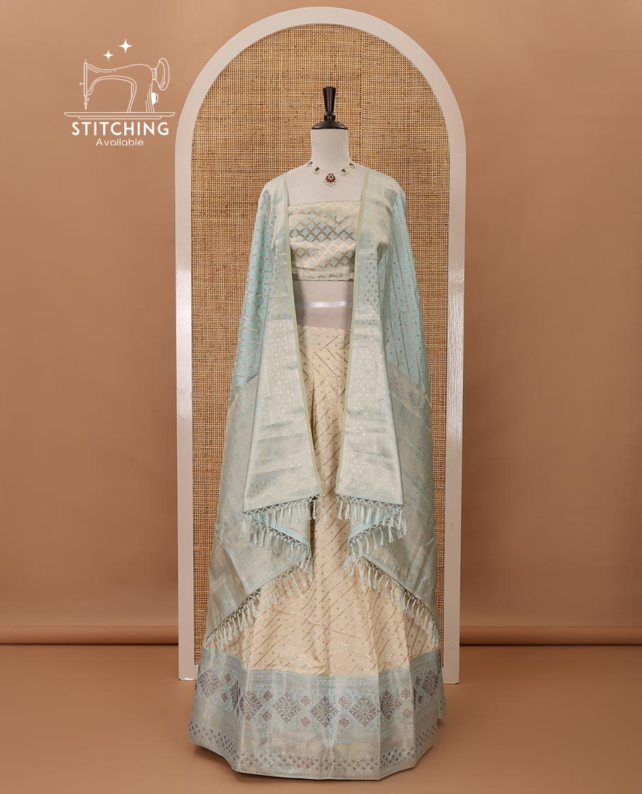 Cream semi-banaras material chudidar,leheriya zari skirt,contrast sea blue zari & swarovski stonework border,jacquard blouse & zari weave dhavani