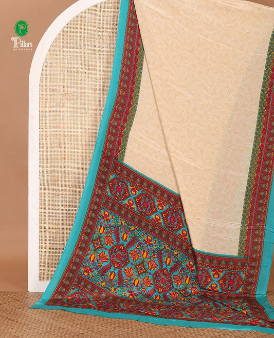 Cream leaf motifs printed crepe silk saree, contrast blue printed blouse, kaleidoscope coloured intricately printed border & pallu
