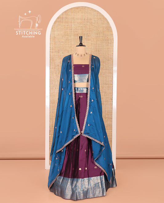 Purple and Blue Semi-Banarasi Half-Saree, Adorned with Zari Buttas on Its Skirt, Complemented by a Contrast Traditional Zari Designs Woven Border, Paired with a Matching Blouse, and a Satin Georgette Embroidered Scallop Dhavani