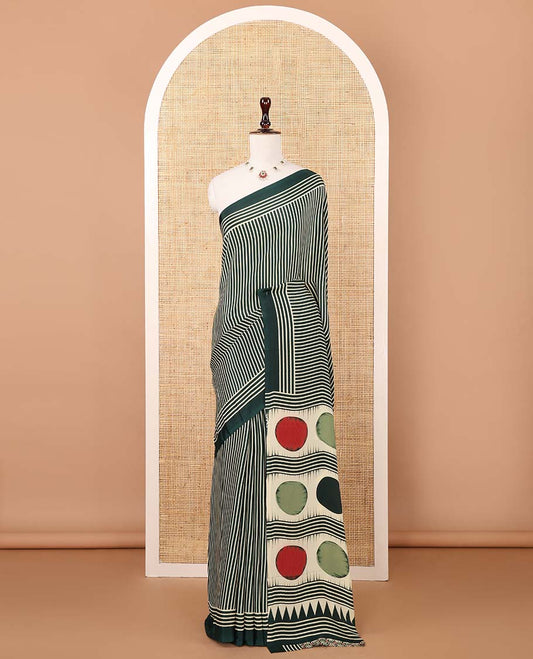 Bottle green vertical stripes printed modal satin saree, a self-border of horizontal stripes print, polka dots printed on the pallu, and an intricate ajrakh-style printed blouse