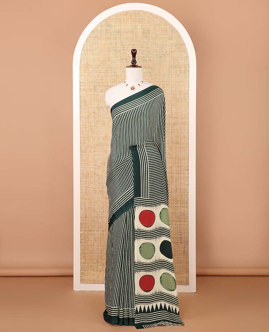 Bottle green vertical stripes printed modal satin saree, a self-border of horizontal stripes print, polka dots printed on the pallu, and an intricate ajrakh-style printed blouse