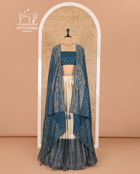 Cream-peacock blue Vichitra half-saree, plain and contrast bordered skirt, contrast leaf buttas blouse, dhavani of buttas and floral creeper designs