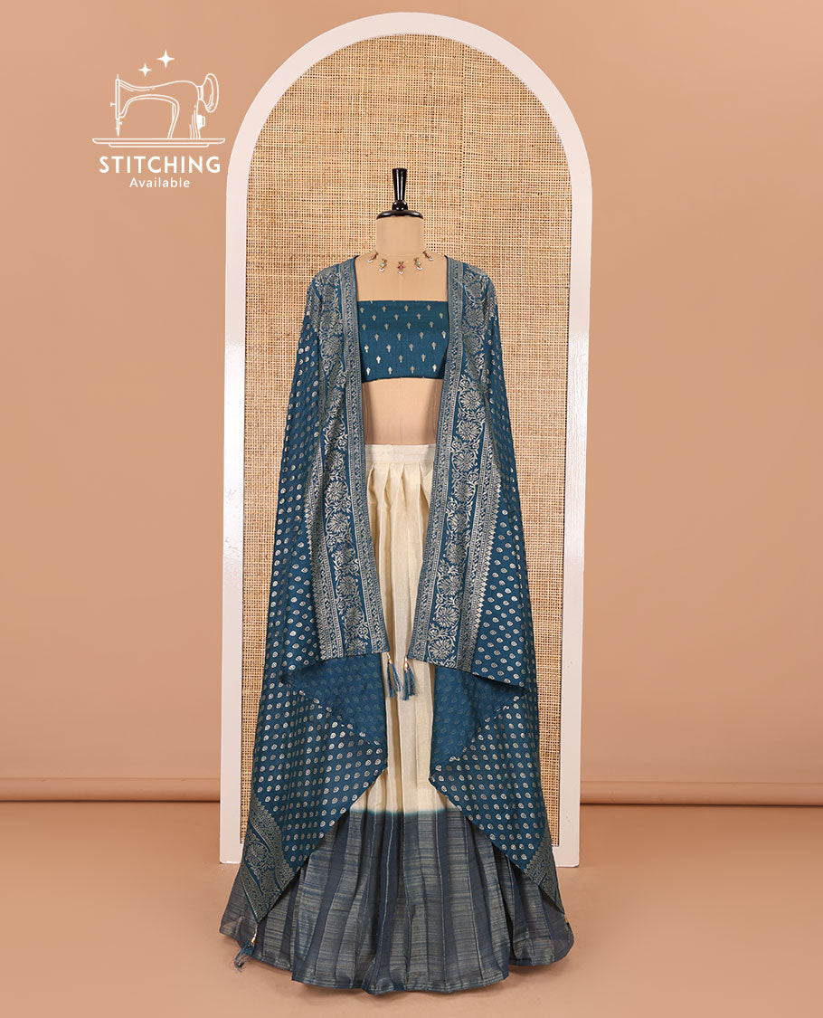 Cream-peacock blue Vichitra half-saree, plain and contrast bordered skirt, contrast leaf buttas blouse, dhavani of buttas and floral creeper designs