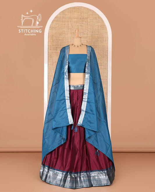 Magenta taffeta silk half-saree, plain with a contrast traditional design bordered skirt, contrast blouse, and traditional zari bordered blouse