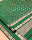 Green Kanchipuram Silk Saree, Detailed with Buttas and Checks, a Zari Rettai Pettu Border of Thazampoo Rekku, and Mayil Designs, Grand Pallu, and a Matching Blouse