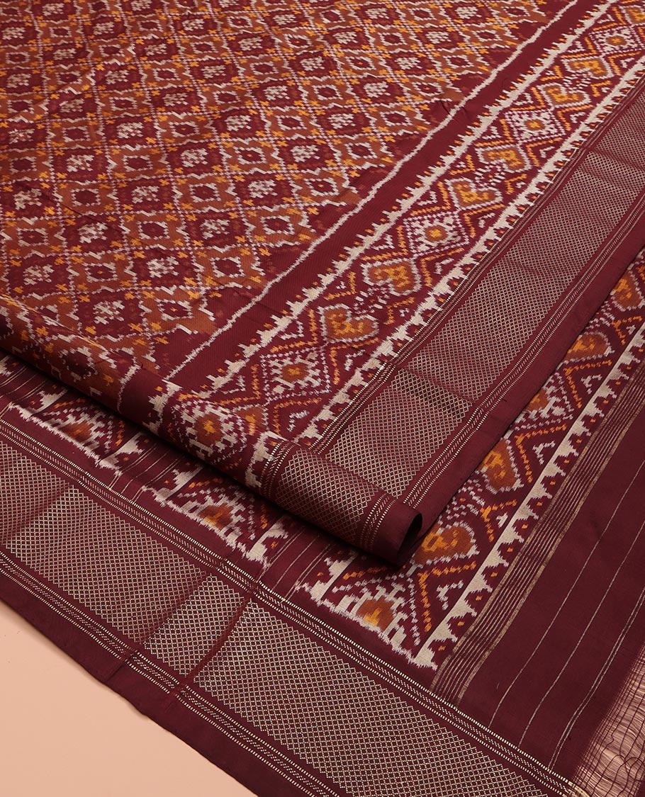 Brown Ikkat Silk Saree, Elevated with Ikkat Checks All Over Its Body, Subtle Border of Jaal Designs, Pallu of Geometric Designs, and Paired with a Matching Blouse