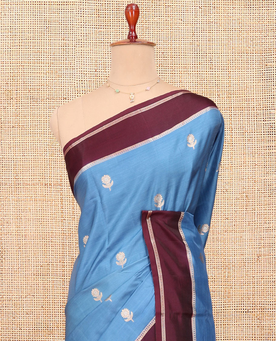 Blue Satin Silk Saree, Mesmerized with Floral Buttas All Over Its Body, Complemented by a Contrast Rettai Pettu Traditional Zari Border, Beautifully Zari Bedecked Pallu, and Paired with a Contrast Blouse