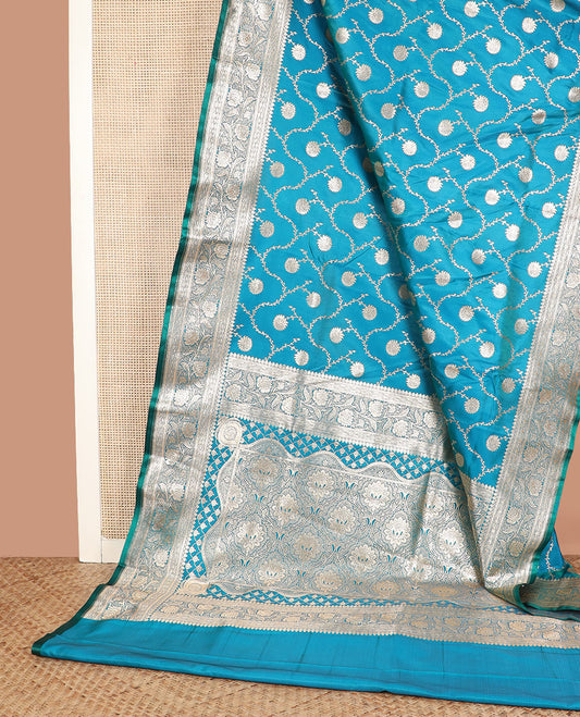Light blue floral jaal jacquard banarasi silk saree, floral creeper design border, and intricate ogee patterned pallu