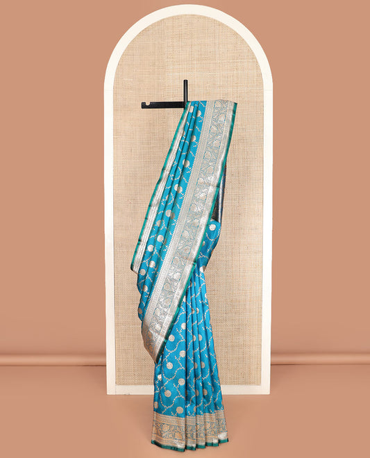 Light blue floral jaal jacquard banarasi silk saree, floral creeper design border, and intricate ogee patterned pallu