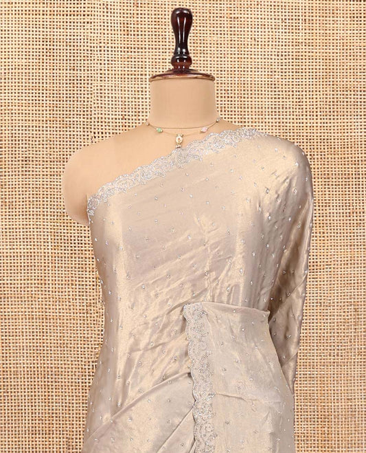 Champagne Designer Saree, Gleamed up with Stone Struck All Over Its Body, Scallop Stone Embroidered Border, and Heavy Embroidered Matching Blouse