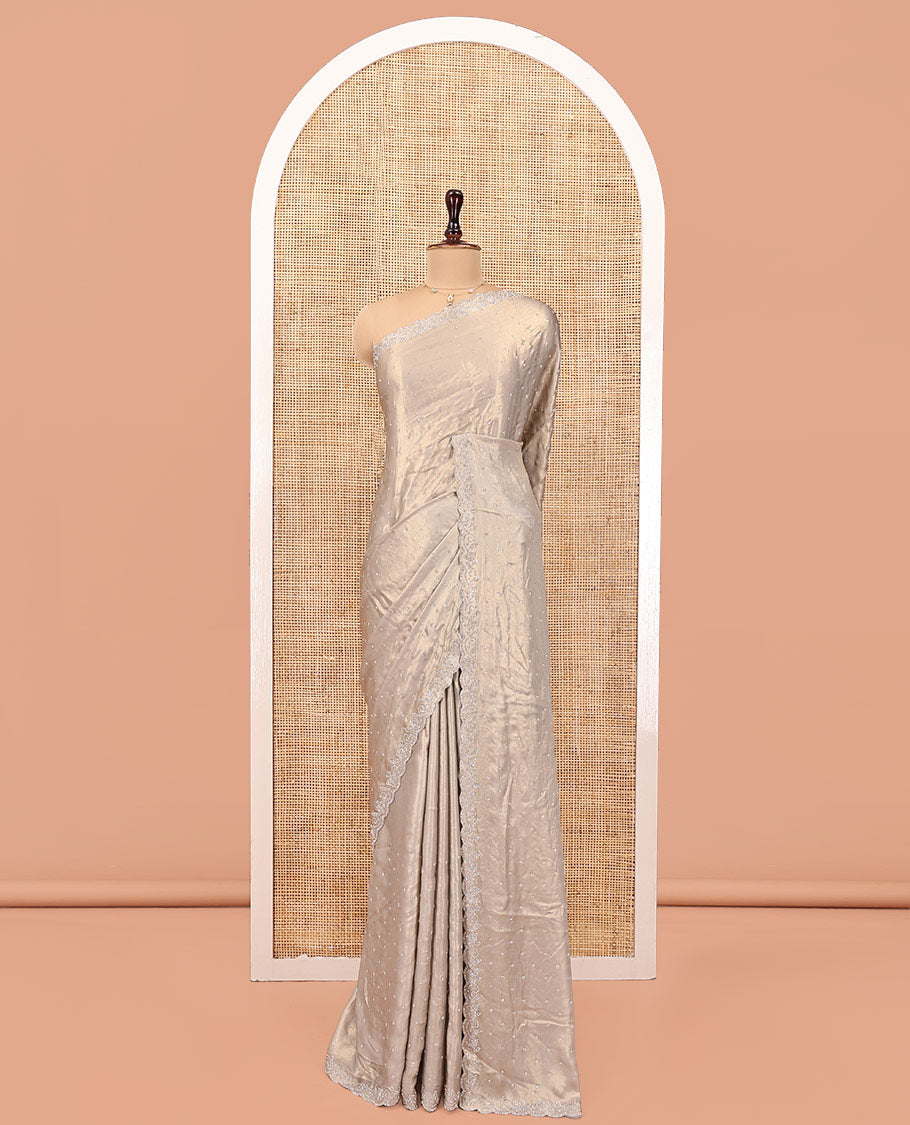 Champagne Designer Saree, Gleamed up with Stone Struck All Over Its Body, Scallop Stone Embroidered Border, and Heavy Embroidered Matching Blouse