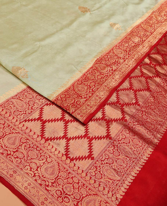 Light Sandal Raw Mango Silk Saree Beautified with Buttas, Featuring a Contrast Paisley Zari-Designed Border, a Zari-Elevated Jaal Pallu, Paired with a Contrast Blouse